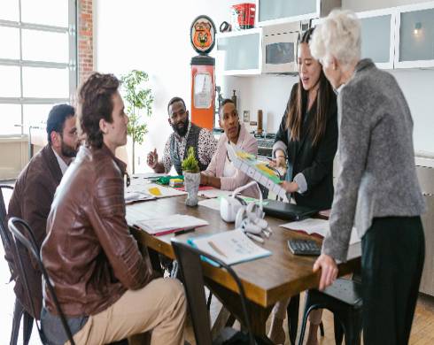 dynamic loan startup, determined expression, planning, photorealistic, sleek office setting with digital devices and loan documents, highly detailed, fast-paced activity, crisp details, monochromatic scheme with pops of color, artificial soft lighting, shot with a 24mm lens